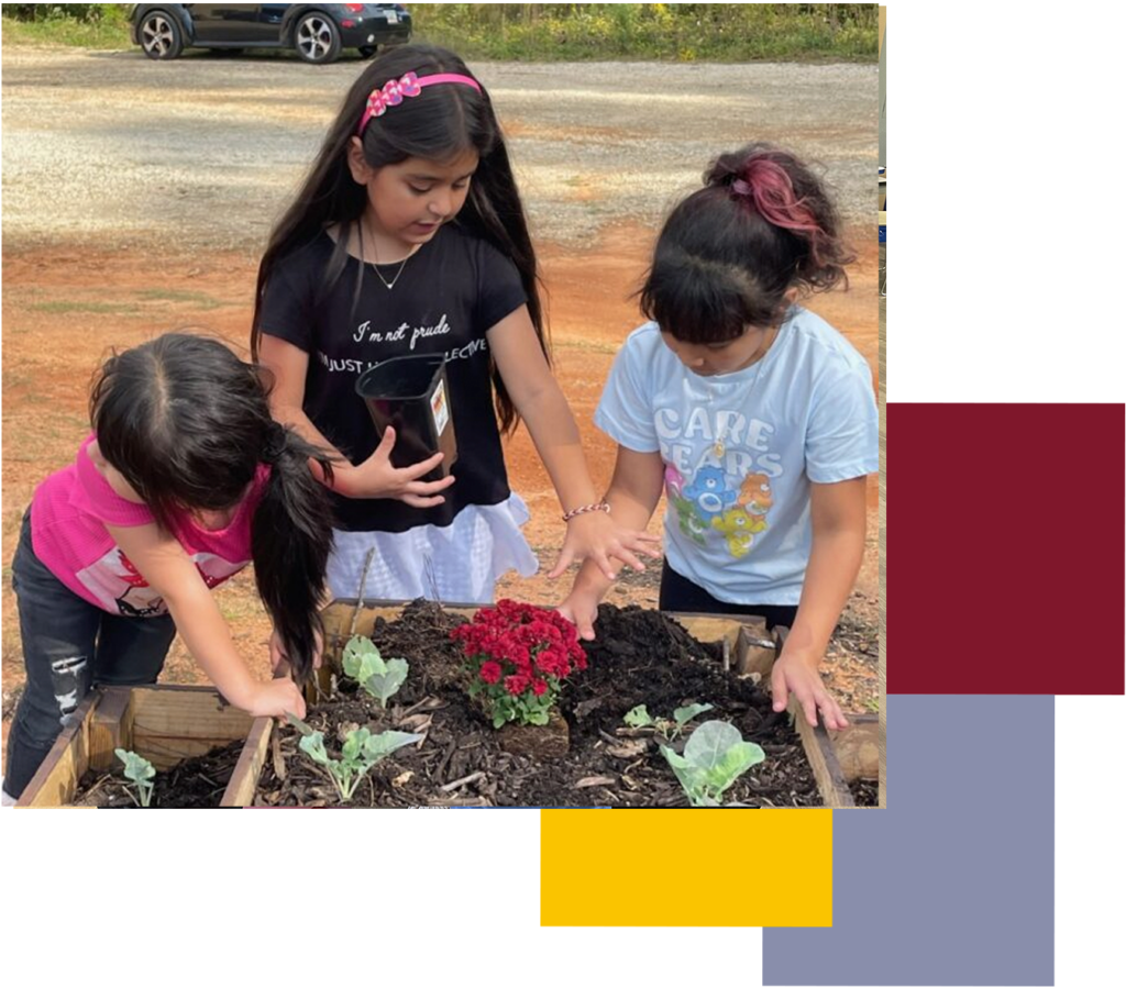 Three kids, girls planting flowers. Project L.E.A.P child care summer camp